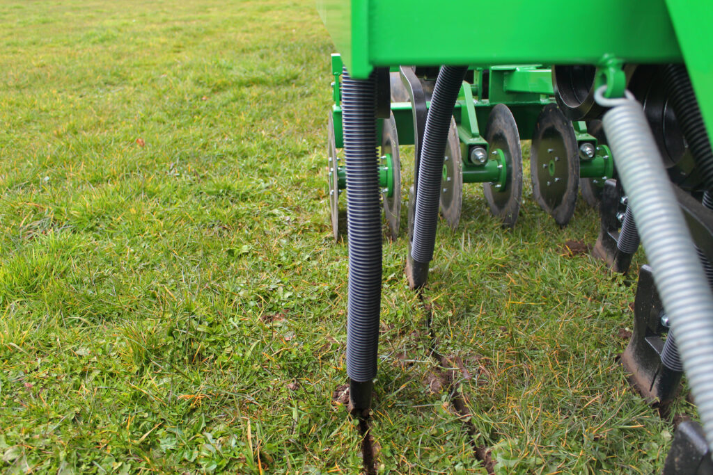 Simtech sprung-tine coulters cutting through grassland surface during no-till drilling.